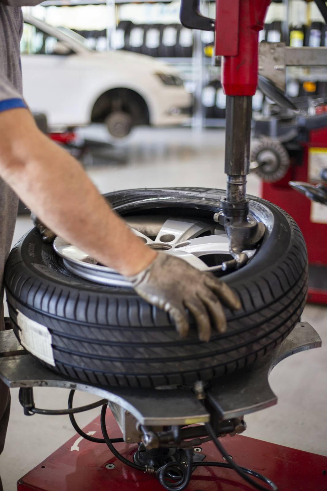 Technician mounting a tire on a tire changer